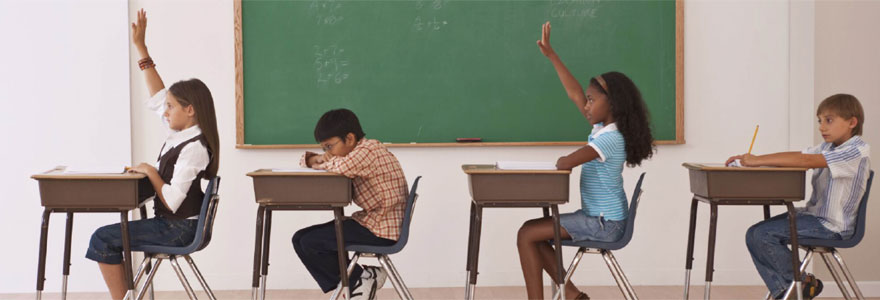 Students in classroom, girls with hands up, boys with heads on desk