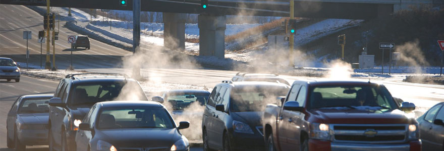 Cars on city street in winter, producing exhaust - photo by Kent Landerholm