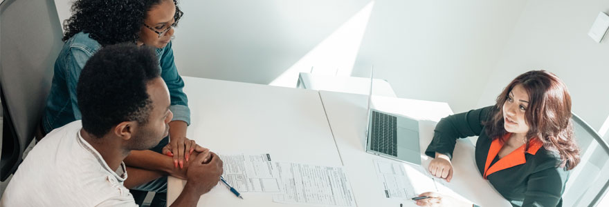 People sitting at desk, with legal documents on top of desk