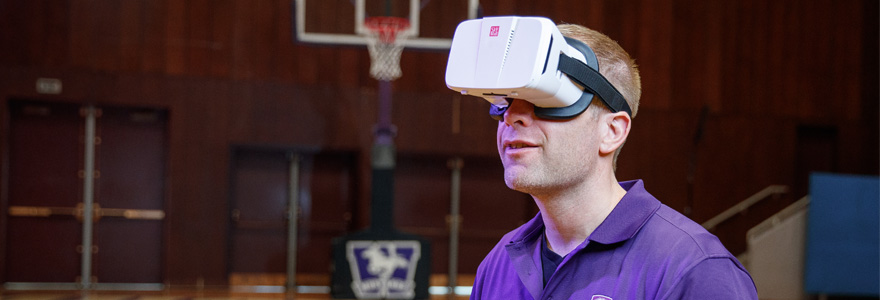 Professor Paul Frewen demonstrates the VR technology at Western Alumni Hall.