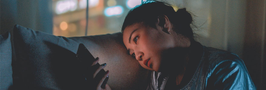 Teen on couch with face lit by light of cellphone, Photo by Mike Toraw of Pexels